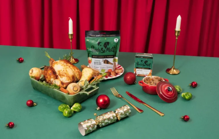 Pooch & Mutt festive dog food and treats displayed as a Christmas dinner table setup