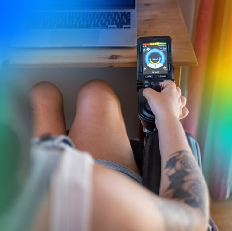 Person using a Bluetooth-enabled wheelchair control device to support independent mobility