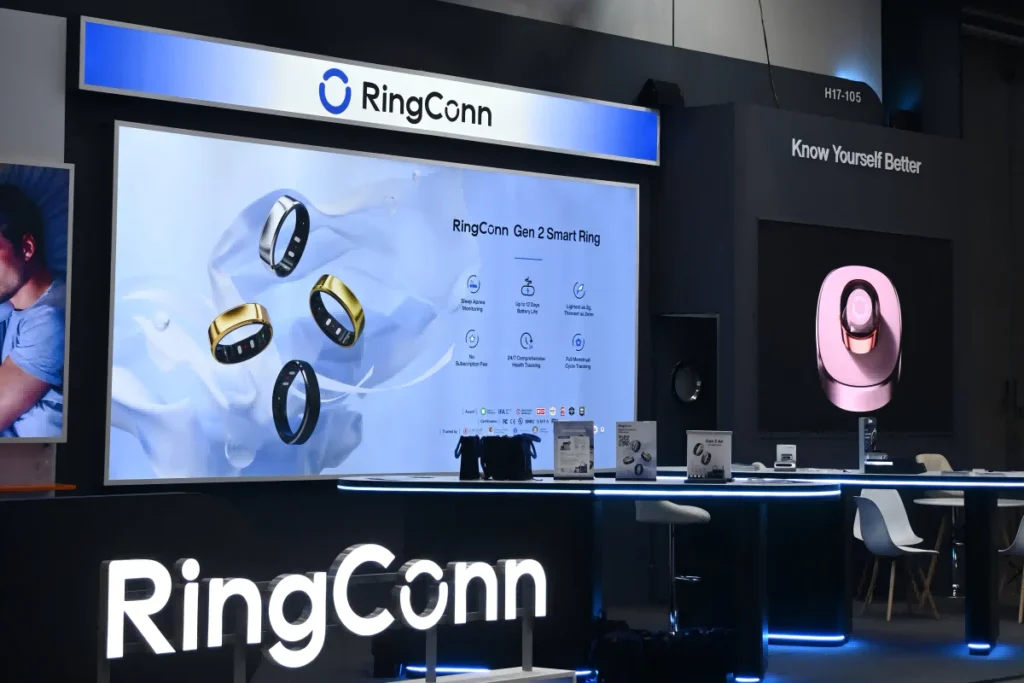 RingConn booth at IFA 2025 featuring a large display of the Gen 2 Smart Ring with health tracking features like Sleep Apnea monitoring and Blood Pressure Insights.