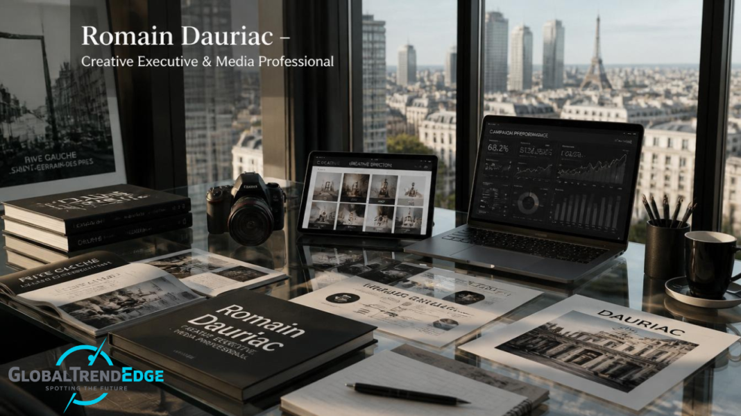 A high-rise desk in Paris overlooking the Eiffel Tower with a laptop showing marketing graphs, a tablet showing a photography portfolio, a DSLR camera, and art books featuring Romain Dauriac branding, featured on GlobalTrendEdge.
